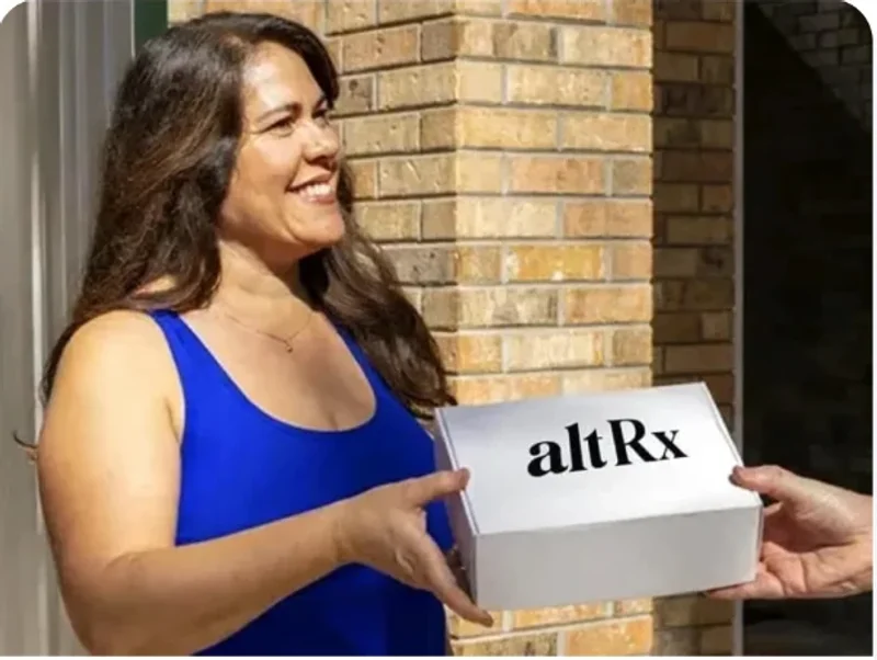 A woman receiving an altRx delivery box at her door
